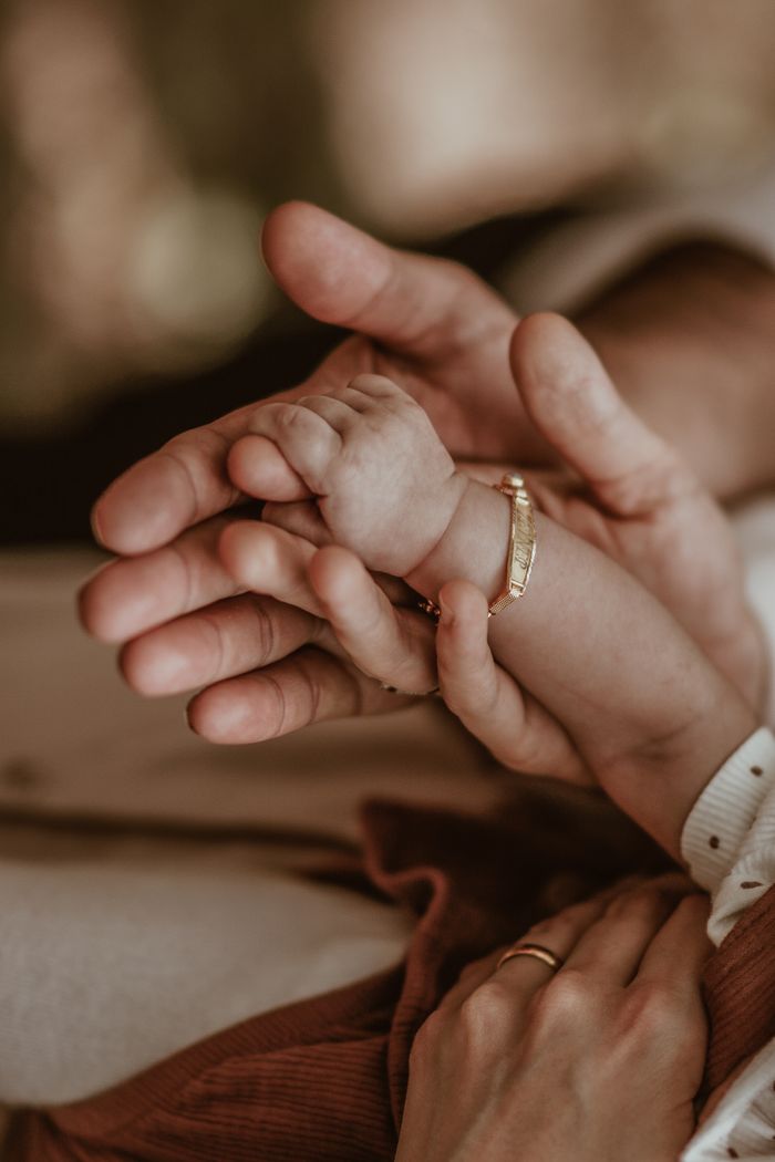 Close-up of adult and baby hands expressing warmth and care, symbolizing love and connection.